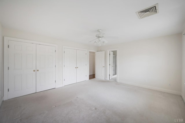 528 Lady Slipper Ln, Lynchburg, VA 24502 - unfurnished bedroom featuring two closets, carpet floors, and a ceiling fan