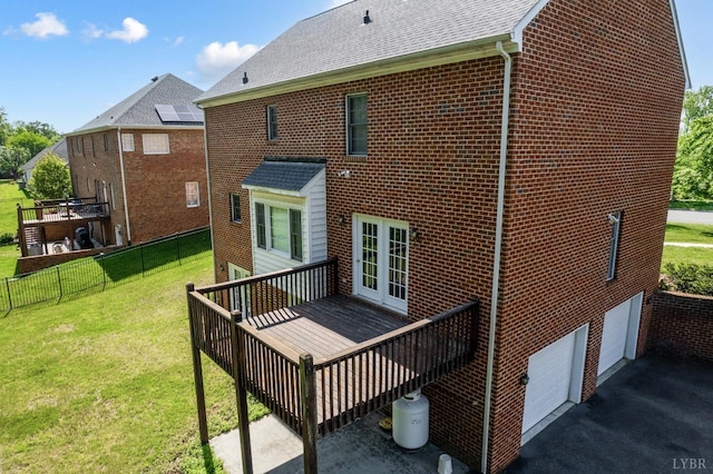 528 Lady Slipper Ln, Lynchburg, VA 24502 - rear view of house with a deck, a garage, brick siding, driveway, and roof with shingles