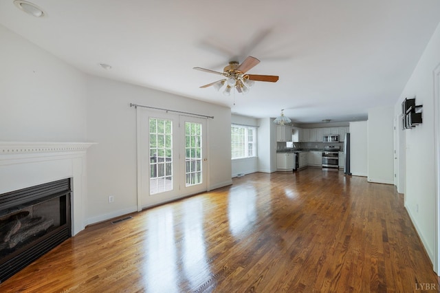 528 Lady Slipper Ln, Lynchburg, VA 24502 - unfurnished living room featuring ceiling fan, a glass covered fireplace, and dark wood finished floors