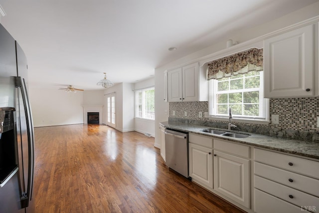 528 Lady Slipper Ln, Lynchburg, VA 24502 - kitchen with appliances with stainless steel finishes, a fireplace, backsplash, and white cabinets