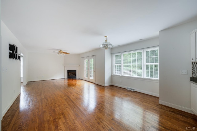 528 Lady Slipper Ln, Lynchburg, VA 24502 - unfurnished living room featuring a fireplace, wood finished floors, a ceiling fan, and a chandelier