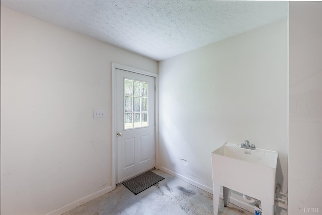 528 Lady Slipper Ln, Lynchburg, VA 24502 - doorway with unfinished concrete flooring and a textured ceiling