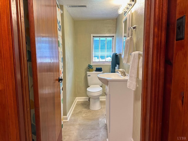 306 Oakridge Blvd, Lynchburg, VA 24502 - full bath featuring vanity, toilet, a textured ceiling, baseboards, and visible vents
