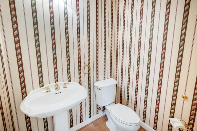 1348 Lake Shore Dr, Forest, VA 24551 - half bath with toilet, wallpapered walls, baseboards, wood finished floors, and a sink