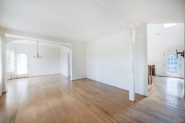 1348 Lake Shore Dr, Forest, VA 24551 - unfurnished living room featuring light wood-type flooring, plenty of natural light, and a chandelier