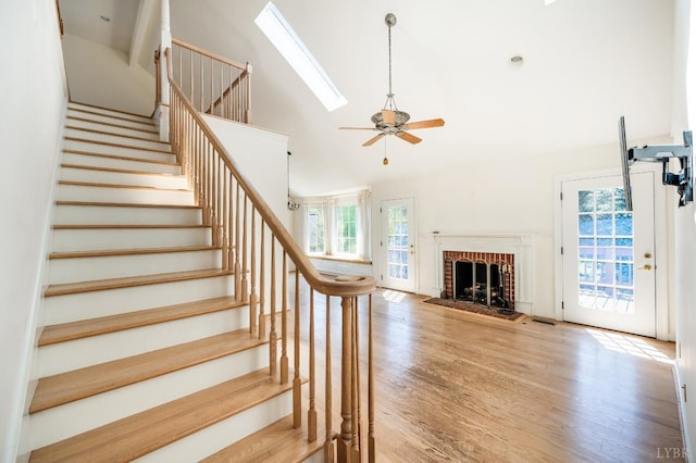 1348 Lake Shore Dr, Forest, VA 24551 - staircase featuring plenty of natural light, a ceiling fan, wood finished floors, a fireplace, and high vaulted ceiling