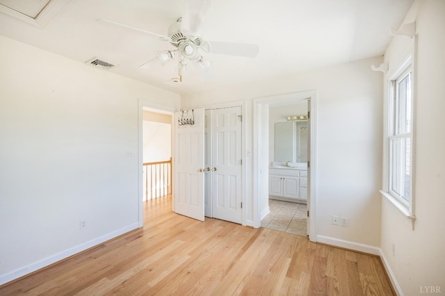 1348 Lake Shore Dr, Forest, VA 24551 - unfurnished bedroom featuring light wood-type flooring, baseboards, a sink, and a closet