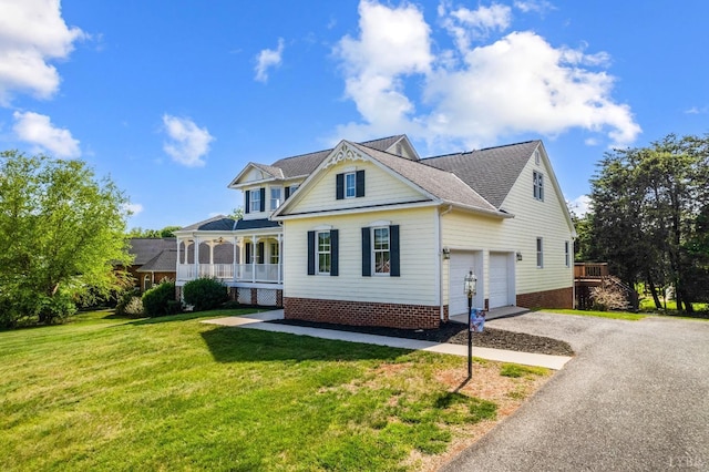 1348 Lake Shore Dr, Forest, VA 24551 - view of front of home with asphalt driveway, covered porch, a front lawn, a garage, and roof with shingles