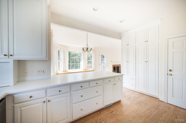 1348 Lake Shore Dr, Forest, VA 24551 - kitchen with light wood-type flooring, white cabinets, a peninsula, and light countertops