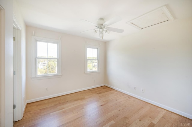 1348 Lake Shore Dr, Forest, VA 24551 - spare room featuring wood finished floors, baseboards, a ceiling fan, and attic access