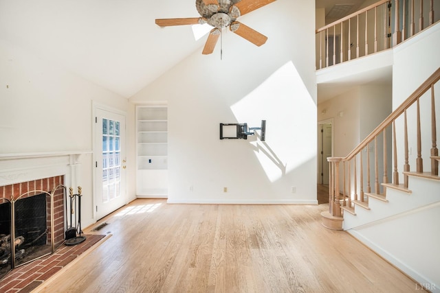 1348 Lake Shore Dr, Forest, VA 24551 - unfurnished living room with high vaulted ceiling, wood finished floors, stairway, and a fireplace