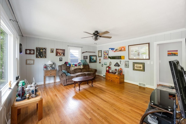 906 Elon Rd, Madison Heights, VA 24572 - living room with ornamental molding, ceiling fan, light wood finished floors, baseboards, and a decorative wall