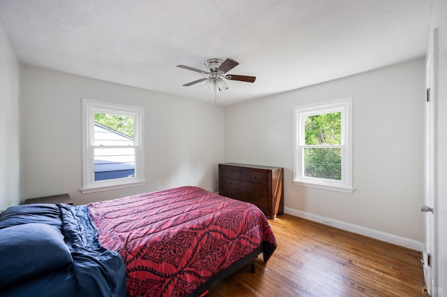 906 Elon Rd, Madison Heights, VA 24572 - bedroom with multiple windows, wood finished floors, baseboards, and a ceiling fan