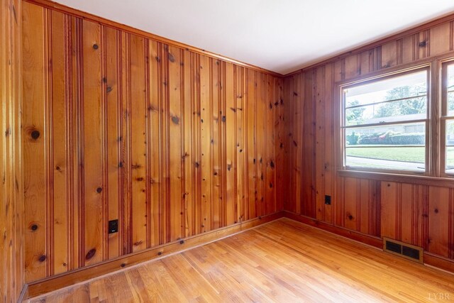 336 Biltmore Ave, Lynchburg, VA 24502 - empty room with light wood-type flooring, wooden walls, visible vents, and baseboards