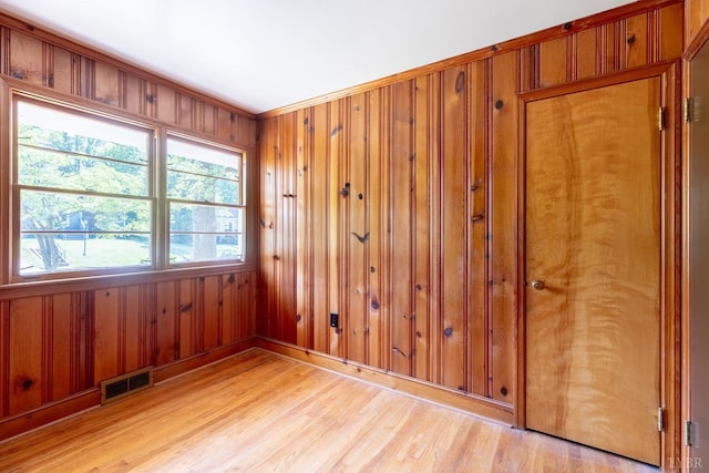 336 Biltmore Ave, Lynchburg, VA 24502 - spare room with baseboards, visible vents, wood walls, crown molding, and light wood-type flooring