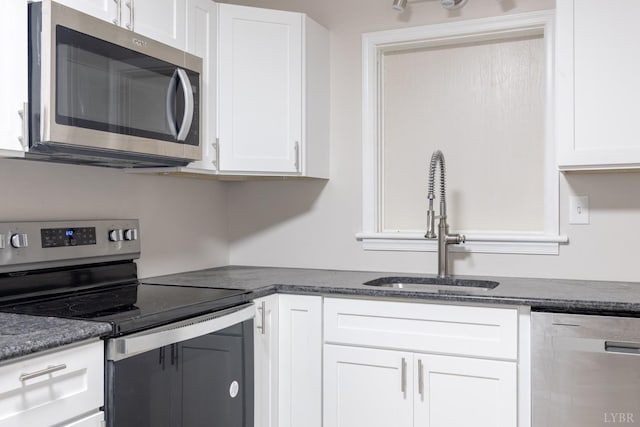 336 Biltmore Ave, Lynchburg, VA 24502 - kitchen featuring a sink, stainless steel appliances, white cabinetry, and dark stone counters