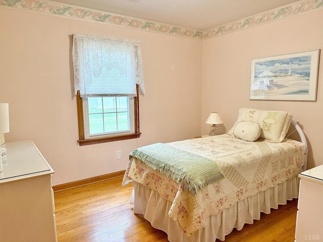 bedroom with baseboards and light wood-style floors