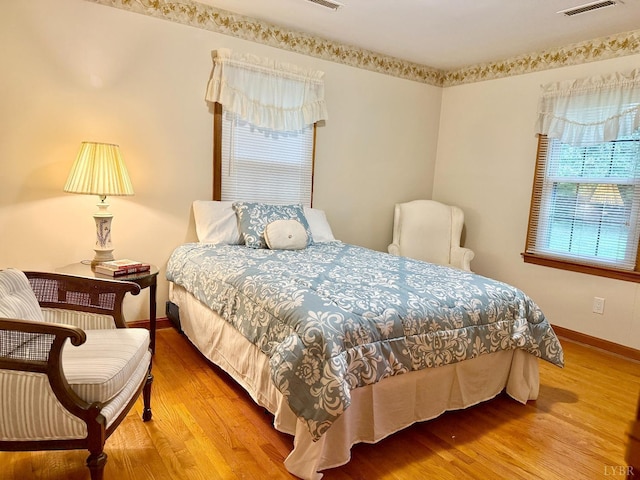 bedroom featuring baseboards and wood finished floors