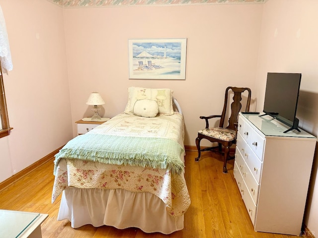 bedroom with baseboards and light wood-style flooring