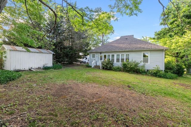 507 Henry St, Gretna, VA 24557 - rear view of house with a lawn, a shed, roof with shingles, and an outdoor structure