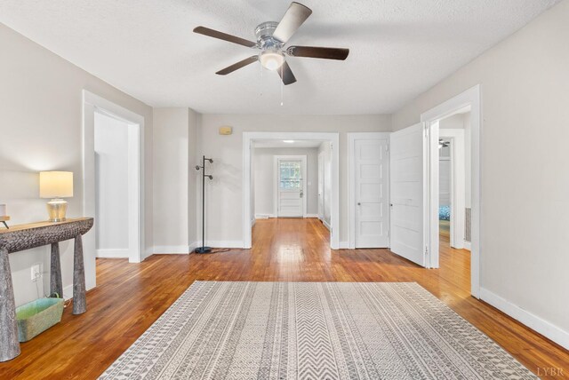 507 Henry St, Gretna, VA 24557 - interior space with a ceiling fan, baseboards, a textured ceiling, and wood finished floors