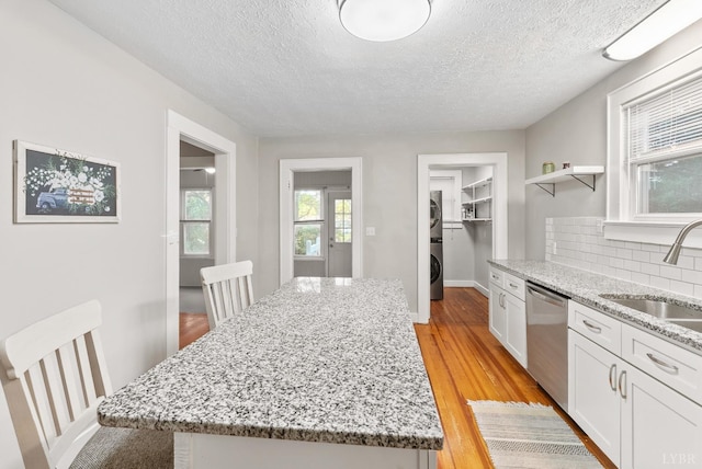 507 Henry St, Gretna, VA 24557 - kitchen featuring a textured ceiling, light wood-type flooring, a sink, and dishwasher