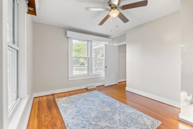 507 Henry St, Gretna, VA 24557 - unfurnished room with baseboards, visible vents, a ceiling fan, and wood finished floors