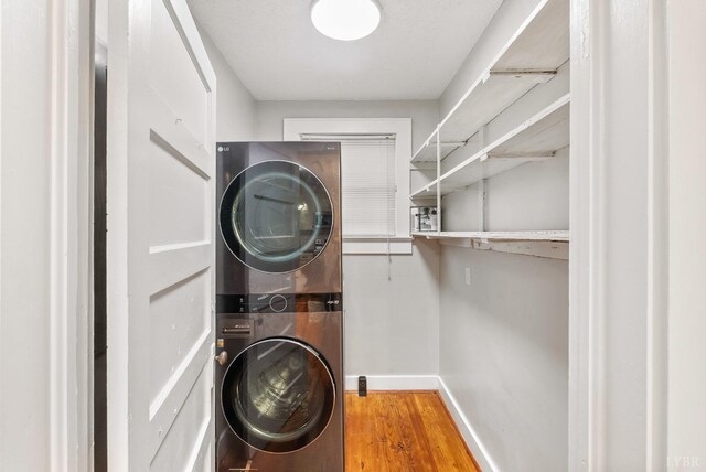 507 Henry St, Gretna, VA 24557 - laundry area featuring laundry area, stacked washer and clothes dryer, baseboards, and wood finished floors
