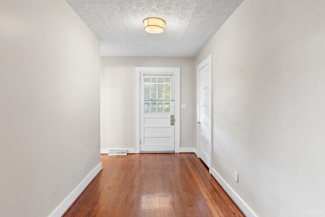 507 Henry St, Gretna, VA 24557 - entryway featuring a textured ceiling, visible vents, baseboards, and hardwood / wood-style flooring