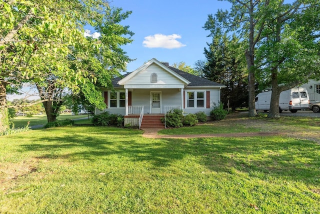 507 Henry St, Gretna, VA 24557 - bungalow featuring covered porch, roof with shingles, and a front lawn