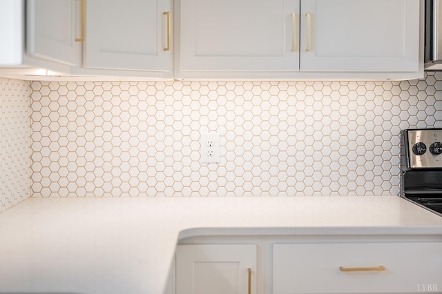 interior details featuring white cabinetry, light countertops, and tasteful backsplash