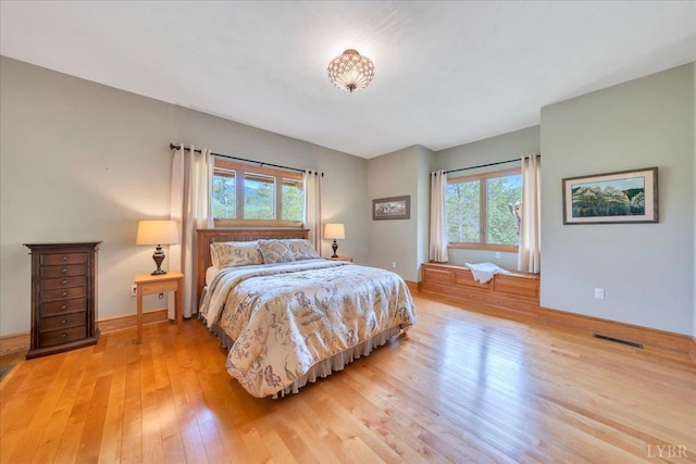 122 Gravelly Ridge Rd, Troutville, VA 24175 - bedroom with light wood finished floors, multiple windows, visible vents, and baseboards