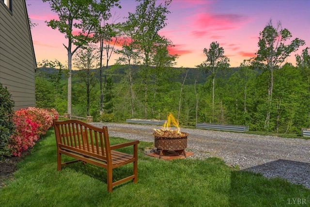 122 Gravelly Ridge Rd, Troutville, VA 24175 - yard at dusk featuring a wooded view and a fire pit