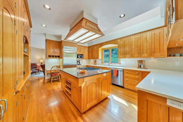 122 Gravelly Ridge Rd, Troutville, VA 24175 - kitchen with brown cabinets, decorative backsplash, stainless steel appliances, light wood-style floors, and a kitchen island
