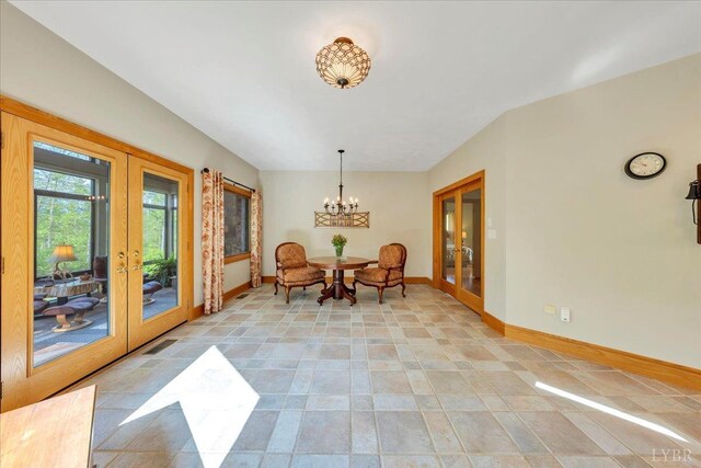 122 Gravelly Ridge Rd, Troutville, VA 24175 - dining space with baseboards, a notable chandelier, french doors, and light tile patterned floors