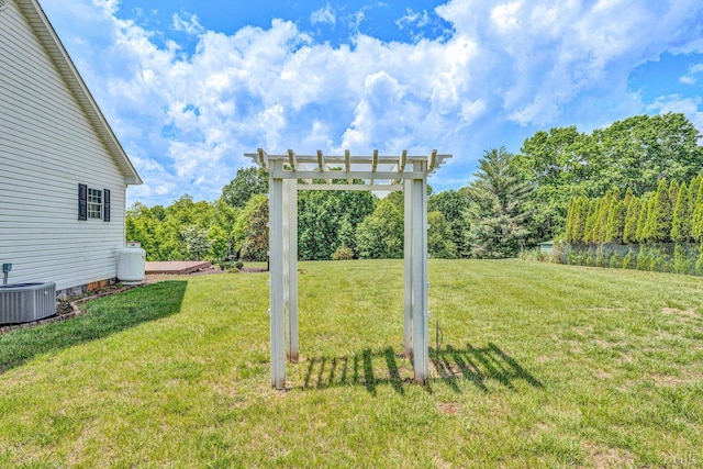 view of yard featuring central AC and a pergola