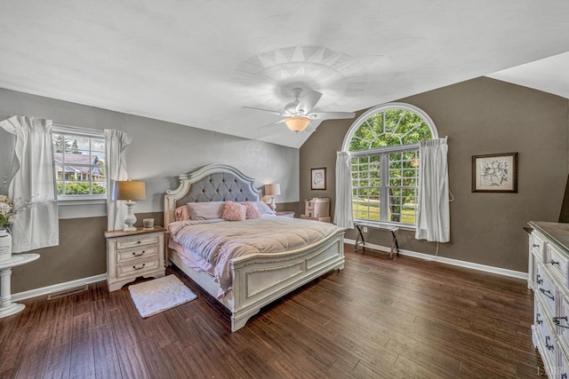 bedroom featuring dark wood-type flooring, visible vents, vaulted ceiling, a ceiling fan, and baseboards