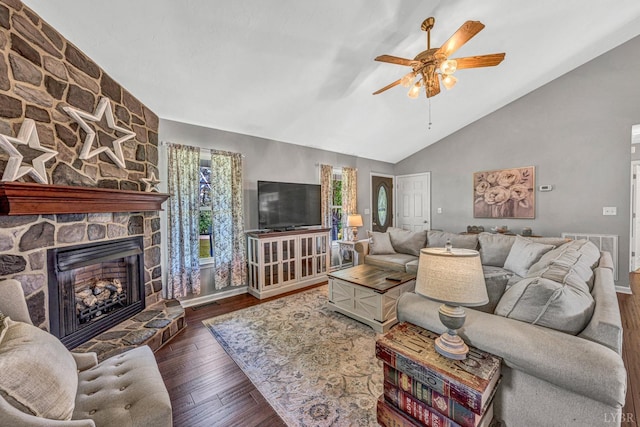 living room featuring lofted ceiling, visible vents, ceiling fan, hardwood / wood-style flooring, and a fireplace