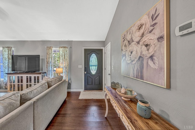 entrance foyer featuring dark wood-style flooring, lofted ceiling, and baseboards