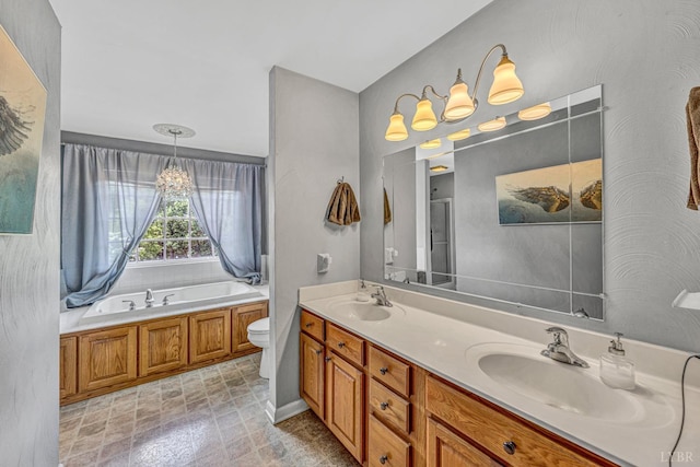 full bathroom with toilet, a garden tub, double vanity, and a sink