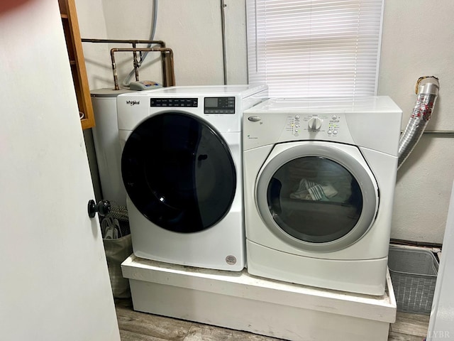 laundry room with separate washer and dryer and wood finished floors