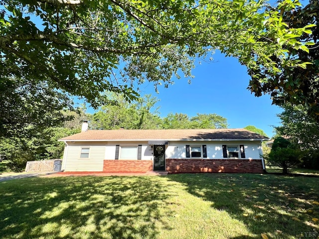single story home with fence, a chimney, a front lawn, and brick siding