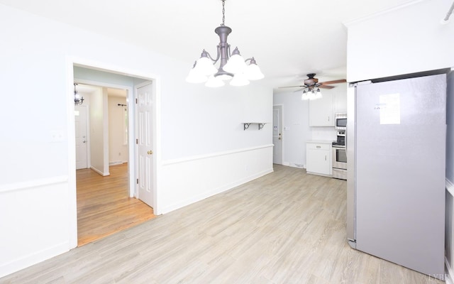 kitchen with white cabinetry, stainless steel appliances, pendant lighting, and light wood-type flooring
