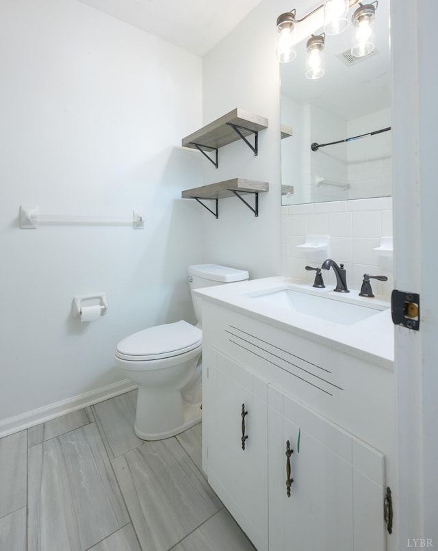 full bath with walk in shower, vanity, toilet, and baseboards