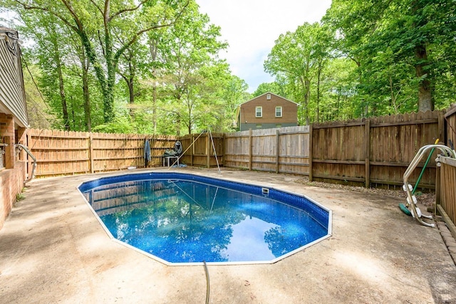 view of swimming pool with a fenced backyard, a patio, and a fenced in pool
