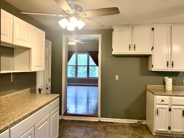 1349 Murray Hollow Rd, Thaxton, VA 24174 - kitchen featuring a ceiling fan, white cabinetry, baseboards, dark tile patterned flooring, and light countertops