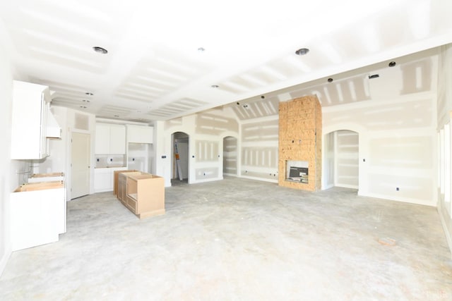 25 Stoney Ridge Blvd, Forest, VA 24551 - unfurnished living room featuring arched walkways and concrete floors