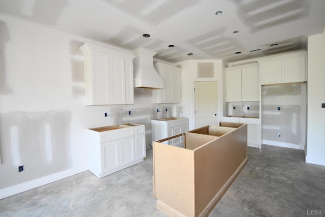 25 Stoney Ridge Blvd, Forest, VA 24551 - kitchen featuring a kitchen island, custom range hood, concrete flooring, and white cabinets