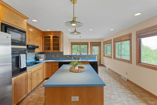 885 Cresthill Rd, Lynchburg, VA 24504 - kitchen with black appliances, backsplash, a sink, glass insert cabinets, and a center island