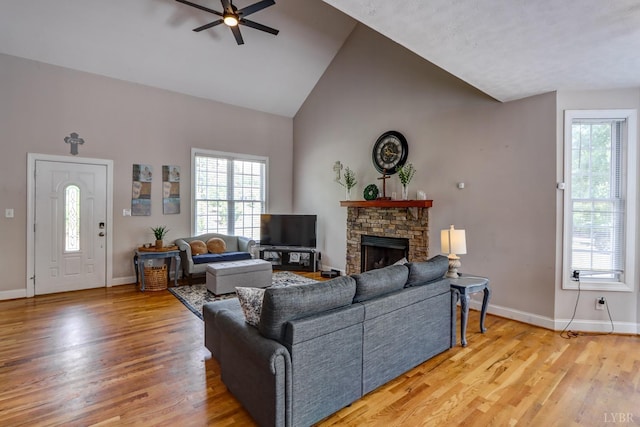 22 Semmes Ct, Rustburg, VA 24588 - living room featuring ceiling fan, healthy amount of natural light, wood finished floors, a fireplace, and high vaulted ceiling